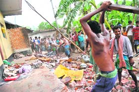Activists of the People’s Committee Against Police Atrocities demolish the house of a CPM member in Lalgarh village