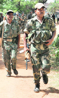 Securitymen head for a violence-hit area at Pirakota, near Lalgarh, on Thursday.