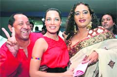 Bollywood actor Celina Jaitley (C) poses with a transgender (R) and a gay rights activist during a news conference in Mumbai