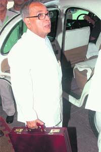 Finance Minister Pranab Mukherjee holds the Budget briefcase as he arrives at Parliament in New Delhi