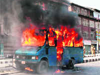 A police vehicle set on fire by a violent mob at Budshah Chowk in Srinagar on Wednesday.