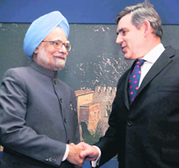 Prime Minister Manmohan Singh shakes hands with his British counterpart Gordon Brown at a meeting in LAqila on Wednesday.