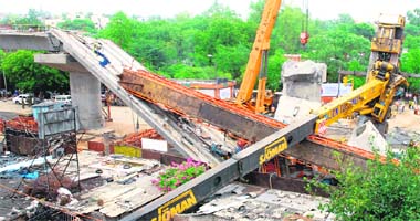 Collapsed cranes are seen at the accident site of a metro bridge in New Delhi