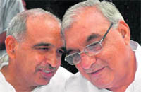 Haryana Chief Minister Bhupinder Singh Hooda (right) and former senior INLD leader Sampat Singh, who joined the Congress in Chandigarh on Monday, seem to be discussing future plans.