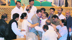 National Conference legislators trying to pacify J&K Chief Minister Omar Abdullah in the state Assembly ahead of his resignation in Srinagar on Tuesday.