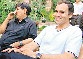 Jammu & Kashmir Chief Minister Omar Abdullah is all smiles after Governor NN Vohra asked him to continue in office, in Srinagar on Thursday.