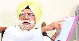 Chairperson of the National Commission for SC/ST Buta Singh shows a document during a press conference in New Delhi on Friday.