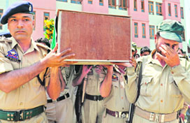 Anguished policemen carry the coffin of a colleague killed in an attack by militants in Srinagar on Saturday. Militants shot dead two policemen and injured two others in two gun attacks in the state.