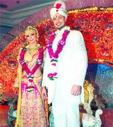 Reality television star Rakhi Sawant (L) announces her engagement to Elesh Parujanwala (R), whom she chose among 16 eligible bachelors, at the conclusion of the series Rakhi Ka Swayamvar at the Hotel Leela Kempinski in Mumbai. Sawant chose Toronto-based Parujanwala as her life partner at the series’ concluding ceremony hosted by NDTV Imagine.