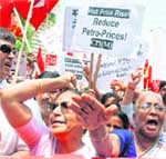 CPM activists raise anti-government slogans during a protest against rising prices of food items and other essential commodities near Parliament House in New Delhi