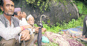 Villagers of Lah in Munsiyari sit with the corpses of their relatives.