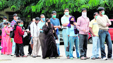 People stand in a queue for swine flu test at the Rajiv Gandhi Institute of Chest Diseases in Bangalore on Tuesday.