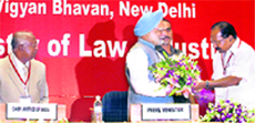 Union Minister for Law and Justice M Veerappa Moily greets PM Manmohan Singh as Chief Justice of India KG Balakrishnan looks on, at the Joint Conference of Chief Ministers and Chief Justices of High Courts, in New Delhi on Sunday.