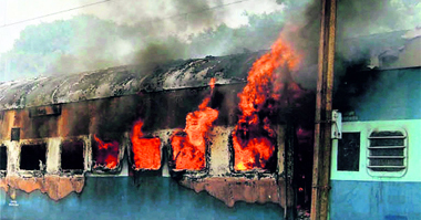 Flames and smoke billow out of the Delhi-Patna Shramjeevi Express at Bihata, near Patna, on Tuesday.
