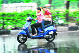Caught in the sudden spell of rain, girls make the most of shower and speed.