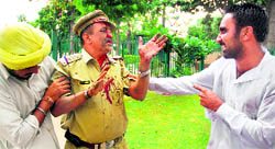 Members of BKU (Ekta) arguing with injured cop during a major lathi charge in Chandigarh on Tuesday.