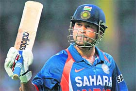MASTER STROKE: Sachin Tendulkar raises his bat after scoring his 44th ODI century during the tri-nation championship final between India and Sri Lanka in Colombo