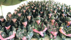 Black Widow cadres gather to lay down their arms before the police at Sontilla in Assam on Tuesday.