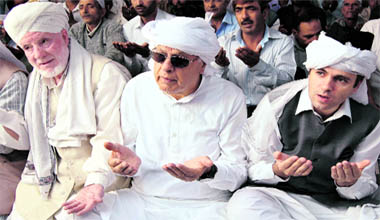 National Conference party patron and Union Minister for Energy and Renewable Sources, Dr Farooq Abdullah with his son J&K CM Omar Abdulah offering Eid prayers at Hazratbal shrine in Srinagar on Monday.