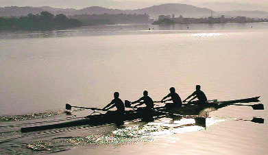 Rowers power their way through waters of Sukhna lake while pactising their skills.