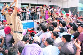 Cops try to control crowd outside the compound of UK Border Agency, VFS Global Services Limited, in Jalandhar