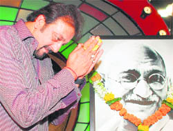 Actor Sanjay Dutt pays homage to a portrait of Mahatma Gandhi on the set of a television reality singing show in Mumbai.