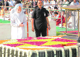 Prime Minister Manmohan Singh pays tributes to Mahatma Gandhi on his 140th birth anniversary at Rajghat in New Delhi on Friday.