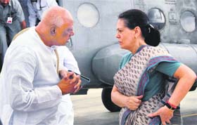 AICC chief Sonia Gandhi with Andhra Pradesh CM K Rosaiah in Hyderabad on Monday after aerial survey of flood-hit areas