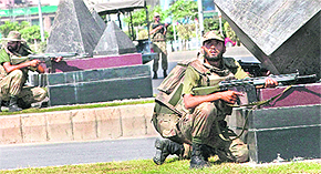 Soldiers take positions outside the main gate of the Pakistan army headquarters after an attack by armed men in Rawalpindi, on the outskirts of Islamabad, on Saturday.
