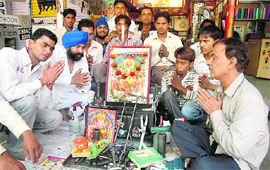 Auto mechanics take part in Vishwakarma puja at the Motor Market in Sector 48, Chandigarh, on Sunday.