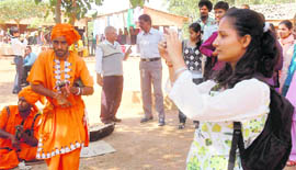 A girl captures some folk artistes on the last day of the First Chandigarh Crafts Mela at Kalagram on Monday.