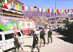 Paramilitary soldiers walk in a market area, decorated in preparation for the arrival of Tibetan spiritual leader Dalai Lama, in Tawang