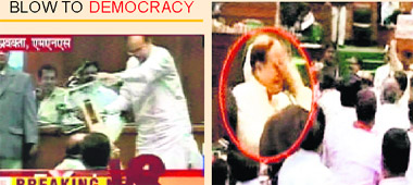 MNS MLAs snatch mike from Abu Azami and (right) the Samajwadi Party leader being assaulted by the legislators at the Vidhan Bhawan in Mumbai on Monday.