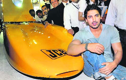 Bollywood actor John Abraham poses with the worlds fastest car ‘JCB Diesel max’ during the Autocar performance show 2009 at Bandra Kurla Compex in Mumbai.