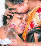 Inconsolable relatives of the injured blast victims at a hospital after the twin blasts at Nalbari in Guwahati on Sunday.