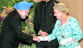 Prime Minister Manmohan Singh greets Britain's Queen Elizabeth II at a banquet for Commonwealth heads of government in Port of Spain, Trinidad and Tobago, on Friday.