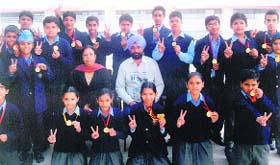 Students of Bhartiya Vidya Mandir Senior Secondary School, Kitchlu Nagar branch, Ludhiana, pose with the principal and sports director after they were honoured