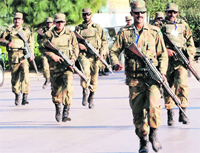 Pakistani soldiers take up position outside the besieged mosque in Rawalpindi 