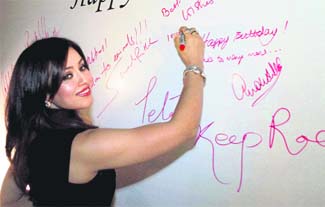 Bollywood actor Mahima Chaudhary signs a board during a function to celebrate the 10th anniversary of People for the Ethical Treatment of Animals (PETA) in Mumbai on Friday.