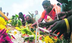Tsunami survivors light candles as a tribute to the victims of the 2004 tsunami, 