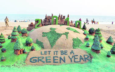 Sand artist Sudarsan Pattnaik sends out a go-green message at Puri beach on Thursday.