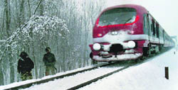 Central Reserve Police Force personnel keep guard near a rail track in Pulwama district of South Kashmir as the Kashmir valley receives a fresh spell of snowfall on Sunday.