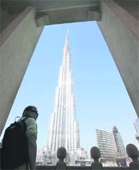 TOWERING OVER ALL: A man looks at Burj Khalifa, the tallest tower in the world, in Dubai. Started during the days of economic boom and built by around 12,000 labourers, the building was inaugurated