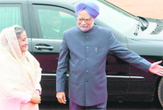 Prime Minister Manmohan Singh gestures while welcoming Bangladesh Prime Minister Sheikh Hasina during her ceremonial reception in New Delhi on Monday.