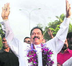 Sri Lankan President Mahinda Rajapaksa waves to supporters after election results were announced in Colombo on Wednesday.