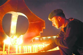 An Army jawan lights a candle to pay tributes to war heroes at the Chandigarh War Memorial on Martyrs’ Day