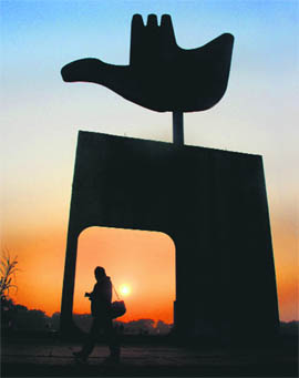 A shutterbug walks past the Open-Hand Monument in search of a picture perfect in Chandigarh