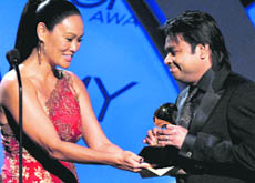 Tia Carrere presents AR Rahman with the Grammy in Los Angeles on Sunday.