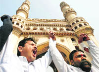 Joint Action Committee activists shout slogans as they form a human chain in front of the Charminar in Hyderabad 