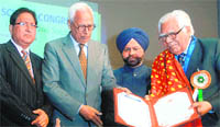 Governor of Jammu and Kashmir NN Vohra gives Lifetime Achievement Award to former Vice-Chancellor of Punjab University and eminent mathematician Prof RP Bambah (right) in Chandigarh 